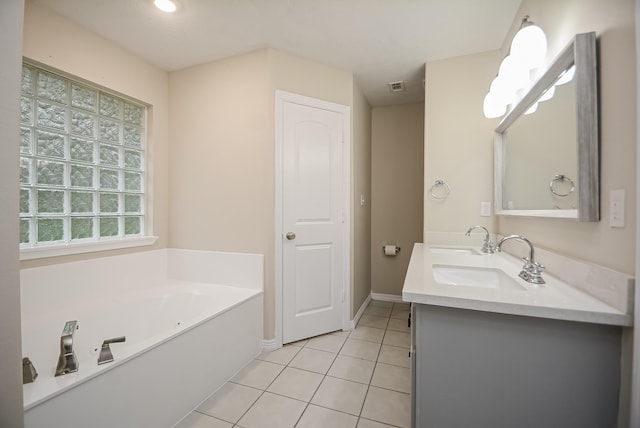 bathroom featuring tile patterned floors, vanity, and a bathtub