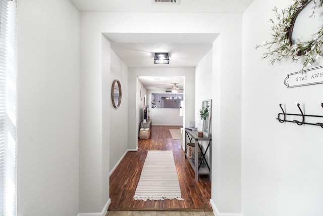 hallway featuring dark hardwood / wood-style flooring