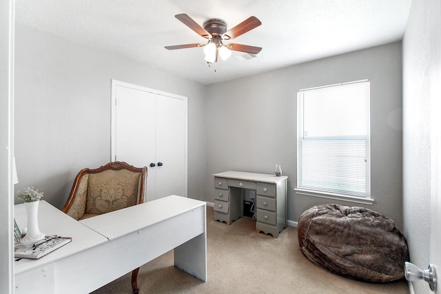 office area featuring ceiling fan and light colored carpet