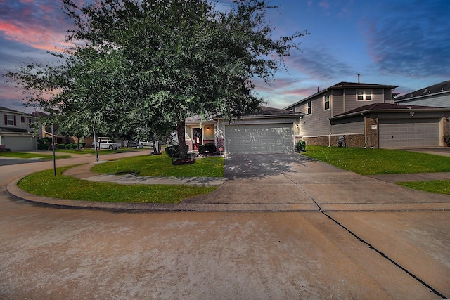 view of front of property featuring a lawn and a garage