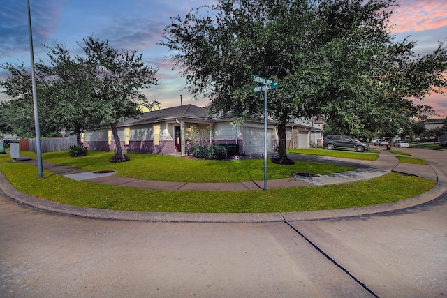 ranch-style home with a lawn and a garage