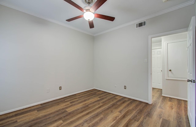 empty room with dark hardwood / wood-style floors, ceiling fan, and crown molding