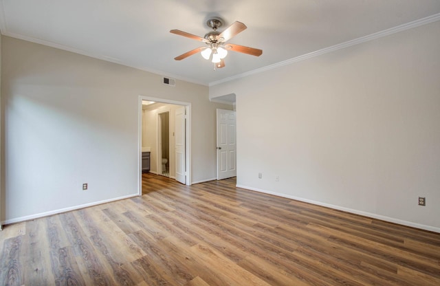 spare room featuring ceiling fan, wood-type flooring, and crown molding