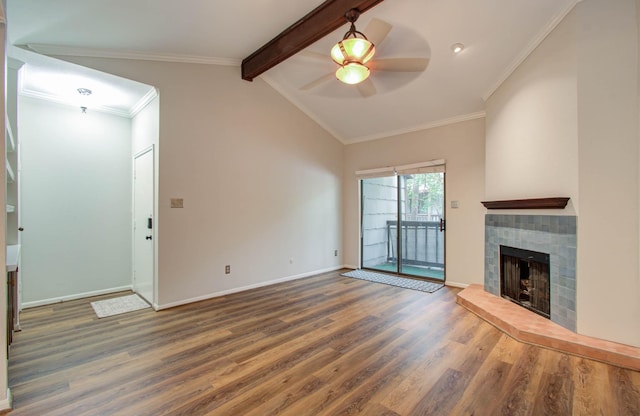 unfurnished living room with lofted ceiling with beams, ceiling fan, dark hardwood / wood-style floors, and a tiled fireplace