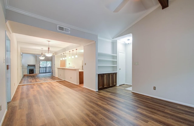 unfurnished living room with built in shelves, ceiling fan, crown molding, wood-type flooring, and lofted ceiling