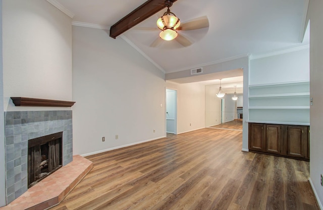 unfurnished living room with hardwood / wood-style floors, vaulted ceiling with beams, ceiling fan, and ornamental molding