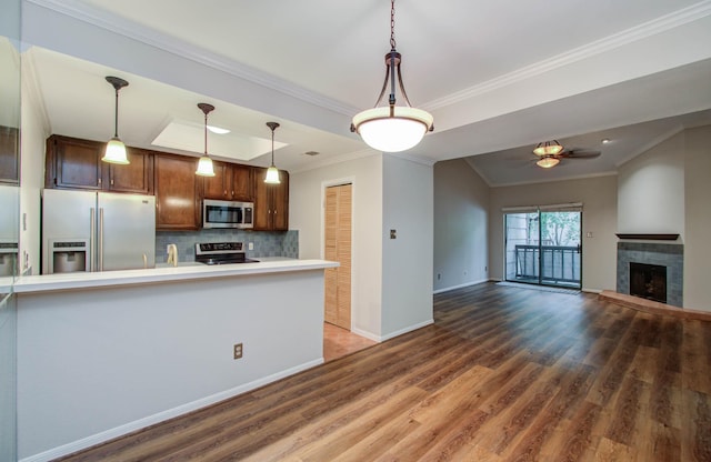 kitchen featuring ceiling fan, tasteful backsplash, crown molding, pendant lighting, and appliances with stainless steel finishes