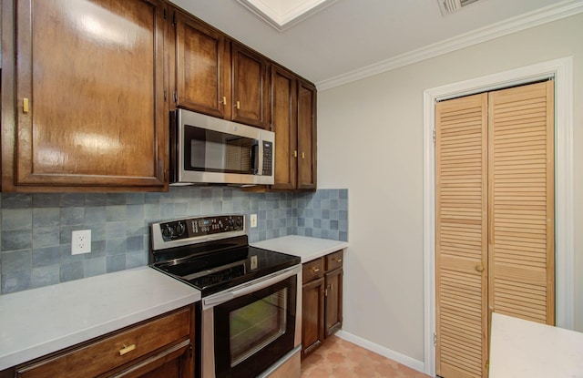 kitchen featuring ornamental molding, stainless steel appliances, and tasteful backsplash