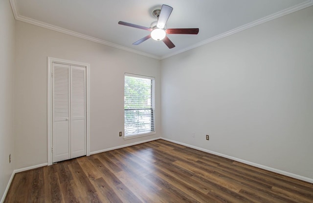 unfurnished bedroom featuring ceiling fan, crown molding, dark wood-type flooring, and a closet