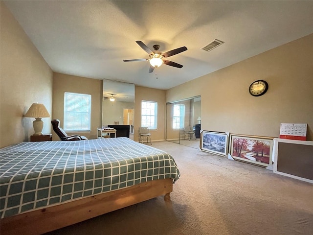 bedroom featuring light carpet, a closet, and ceiling fan