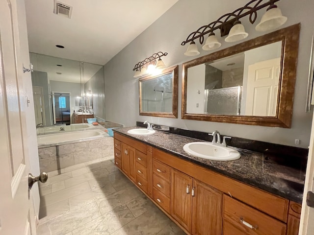 bathroom featuring vanity and shower with separate bathtub