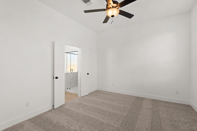 empty room featuring a ceiling fan, light carpet, visible vents, and baseboards