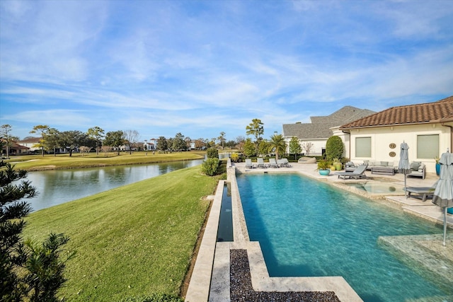 view of pool featuring a yard, a patio, and a water view