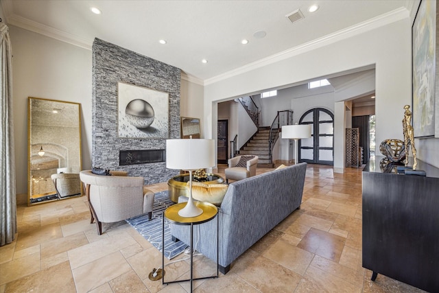 living room featuring crown molding and a fireplace