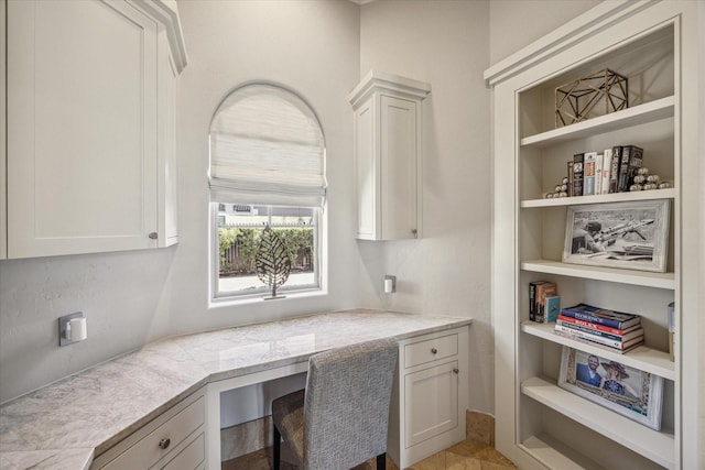 office space with built in shelves and built in desk