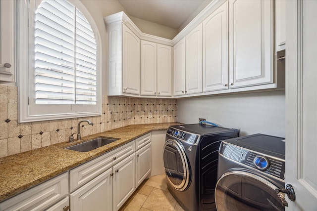 laundry room with cabinets, separate washer and dryer, sink, and light tile patterned floors