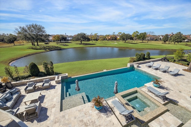 view of pool with an in ground hot tub, a water view, a patio area, and a lawn