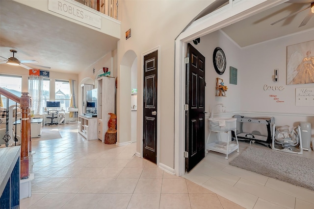 hall with light tile patterned floors and ornamental molding