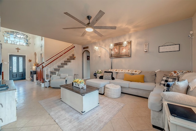 living room with ceiling fan and light tile patterned flooring