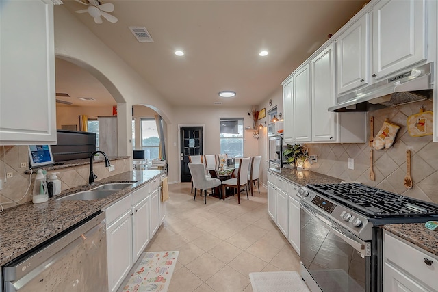 kitchen with white cabinetry, sink, dark stone counters, and appliances with stainless steel finishes