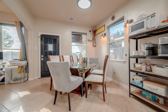 dining area featuring light tile patterned floors