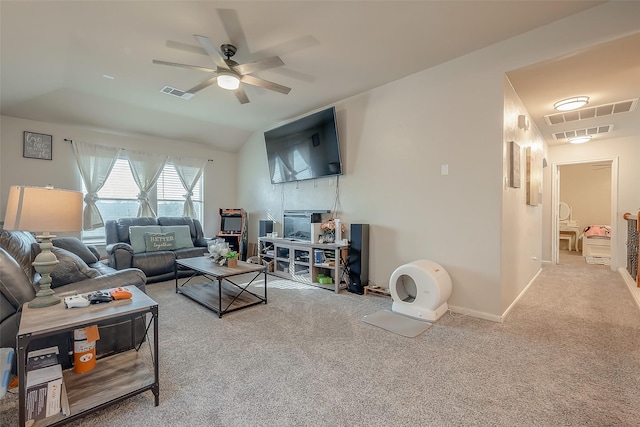 living room with carpet floors, vaulted ceiling, and ceiling fan