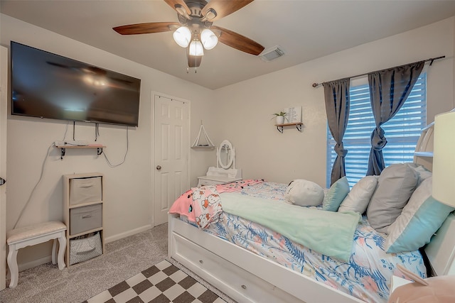 bedroom featuring ceiling fan and light carpet