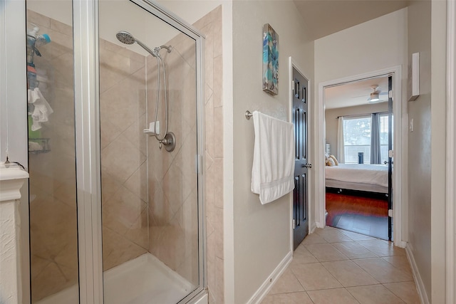 bathroom with tile patterned flooring, ceiling fan, and a shower with shower door