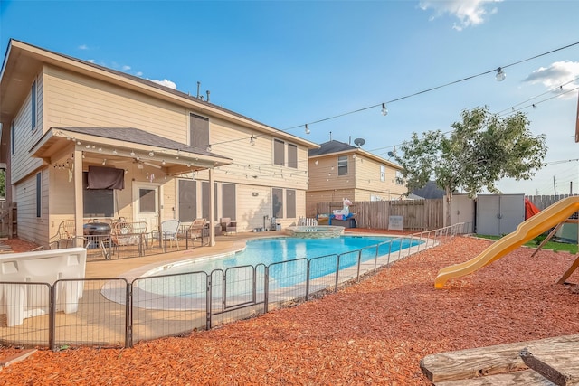 view of pool with a playground and a patio area