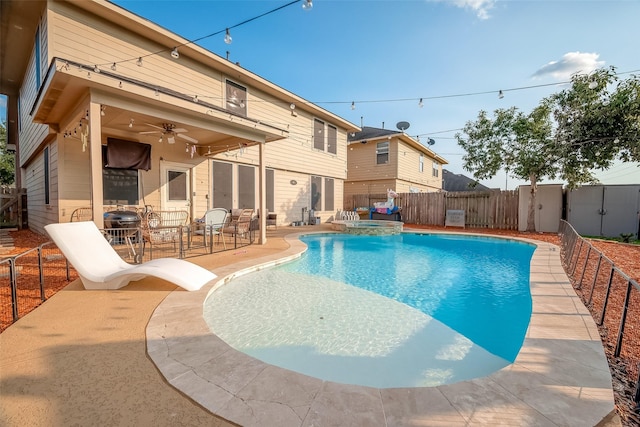 view of pool with an in ground hot tub, a patio, and ceiling fan