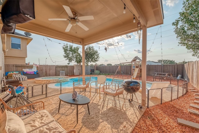 view of patio with a playground and a pool with hot tub