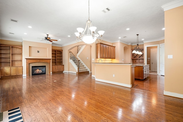 interior space featuring hanging light fixtures, hardwood / wood-style flooring, and ornamental molding