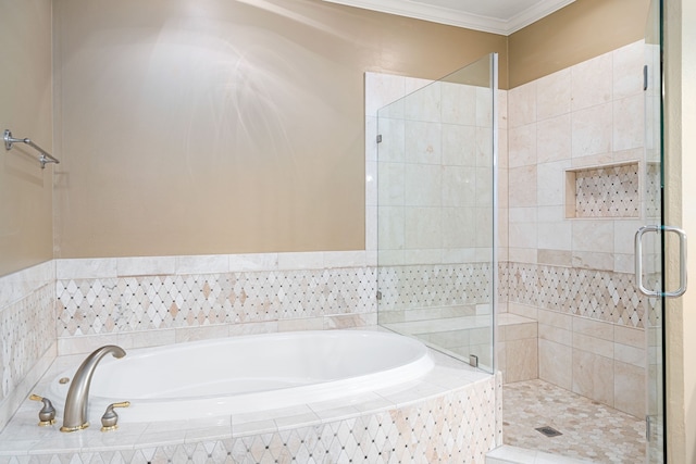 bathroom featuring crown molding and separate shower and tub