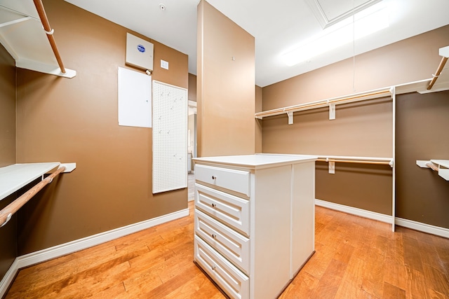 spacious closet with light hardwood / wood-style flooring