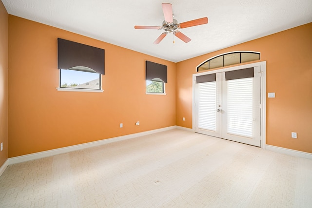 unfurnished room with ceiling fan and french doors