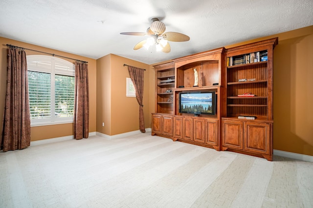 unfurnished living room with light carpet, ceiling fan, and a textured ceiling