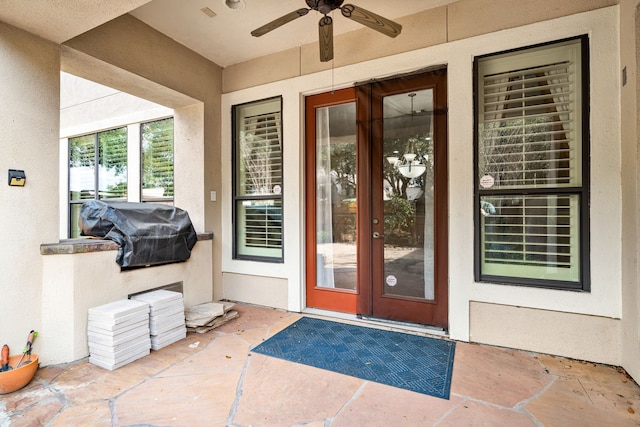 property entrance with a patio, french doors, and ceiling fan