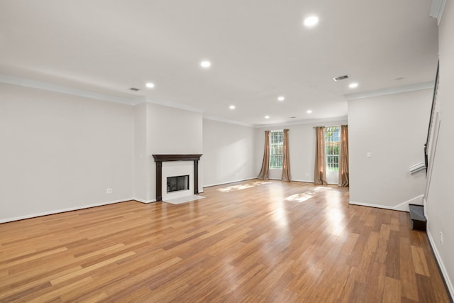 unfurnished living room with light wood-type flooring and crown molding