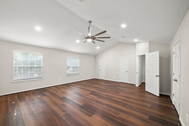 interior space featuring ceiling fan, dark wood-type flooring, and lofted ceiling