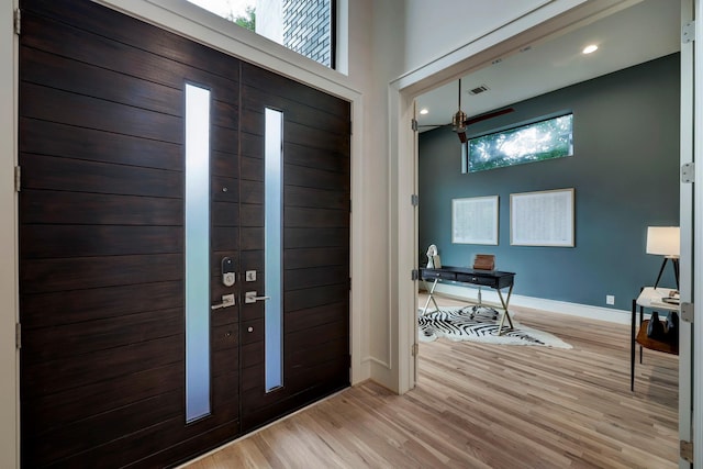 entrance foyer featuring ceiling fan, light hardwood / wood-style floors, and a healthy amount of sunlight