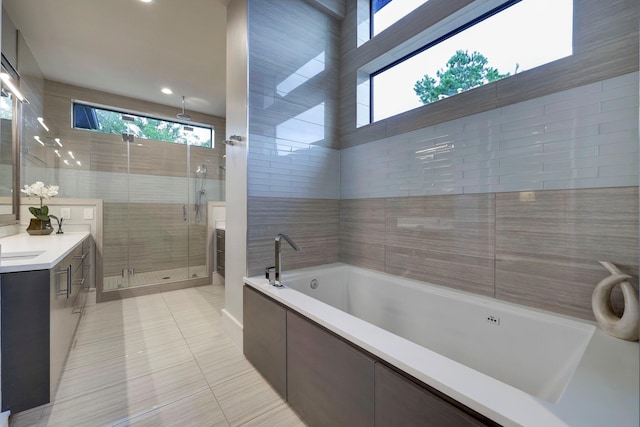 bathroom with tile patterned flooring, vanity, and shower with separate bathtub