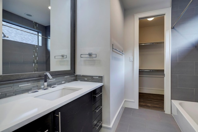 bathroom with tasteful backsplash, tile patterned floors, and vanity