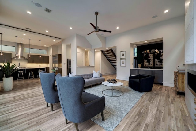 living room with ceiling fan and light hardwood / wood-style floors