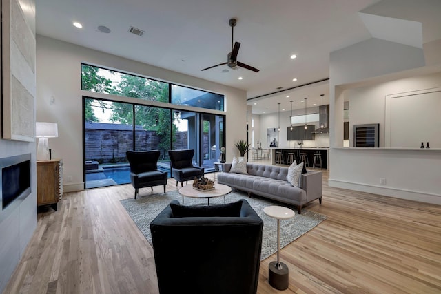 living room featuring light hardwood / wood-style floors and ceiling fan