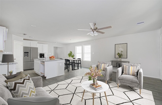 living room featuring hardwood / wood-style floors and ceiling fan