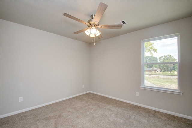 spare room with ceiling fan and light carpet