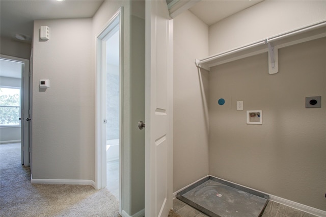 clothes washing area with hookup for an electric dryer, washer hookup, and light colored carpet