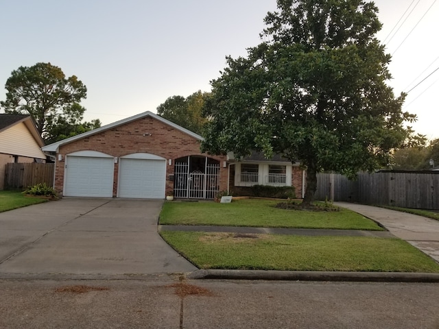 view of front of home featuring a garage and a front lawn