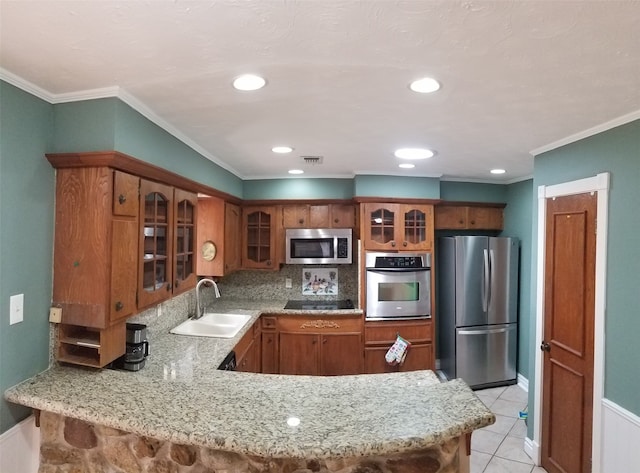 kitchen with kitchen peninsula, appliances with stainless steel finishes, crown molding, sink, and light tile patterned floors