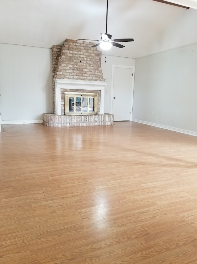 unfurnished living room with light hardwood / wood-style floors, a brick fireplace, and ceiling fan